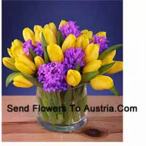 Yellow Tulips Arranged Beautifully In A Glass Vase - Please Note That In Case Of Non-Availability Of Certain Seasonal Flowers The Same Will Be Substituted With Other Flowers Of Same Value