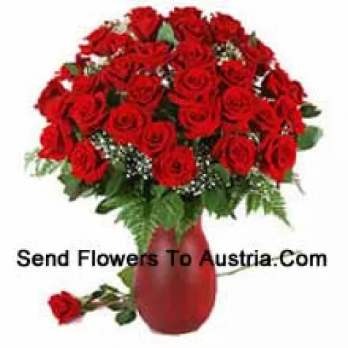41 Red Roses And Seasonal Fillers In A Glass Vase