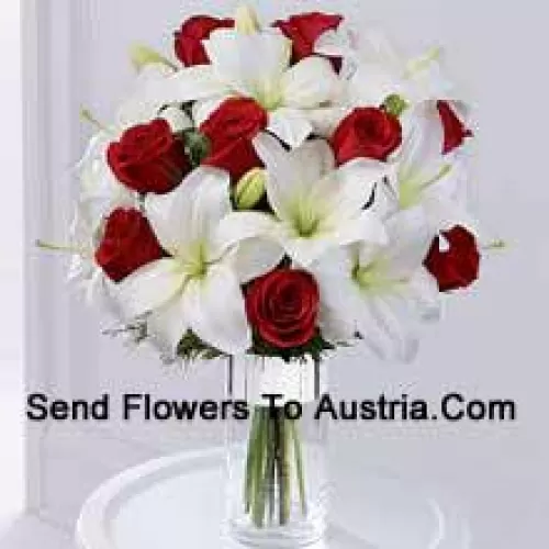 This product is a sleek and elegant way to spread goodwill for the holiday season. Red roses are set to catch the eye arranged amongst white Oriental lilies in a clear glass cylinder vase wrapped in silver ribbon to create a seasonal display of heartfelt wishes for a magical holiday. (Please Note That We Reserve The Right To Substitute Any Product With A Suitable Product Of Equal Value In Case Of Non-Availability Of A Certain Product)